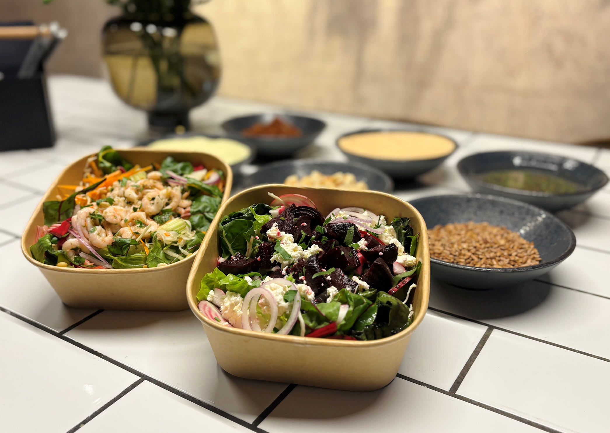 Lunch table at a café with salad, sandwich, beer and juice.